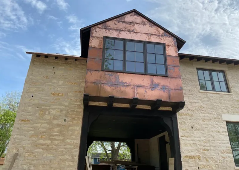 Copper metal panel facade on a stone building for Roof Repair in Bigfork