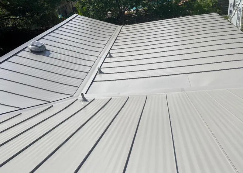 Solar attic fan installed on a metal roof for Roof Ventilation in Bigfork